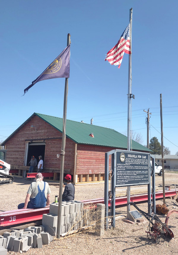 IHS President Jim Winchell and donator Vicki Malleck over-seeing the blacksmith shop's move to town.